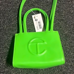 Brand New Tellfar bag with tags plus original bag it comes in. Never worn.